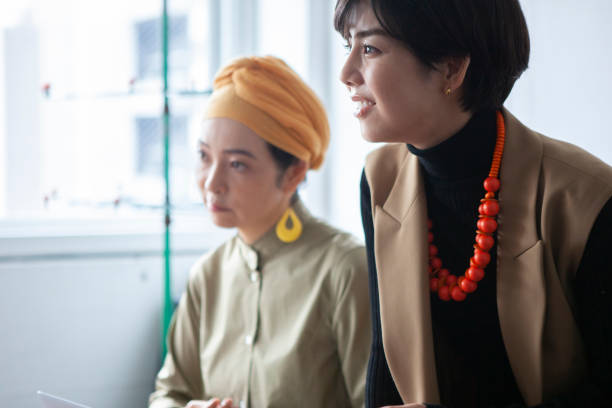 istock Young businesswoman chatting with colleagues in a creative office. 1458996773