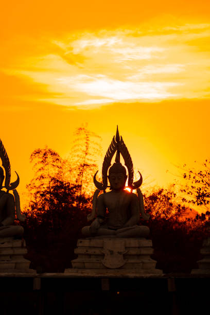 Golden Buddha statue with beautiful sunset for background