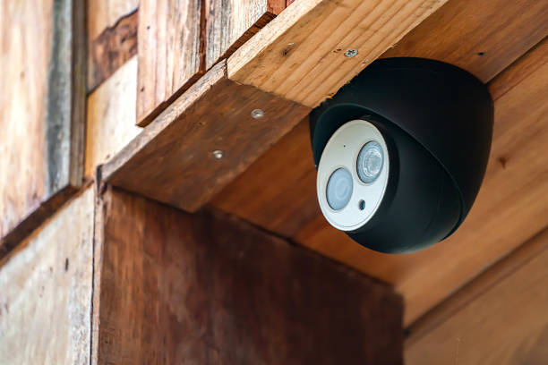 istock close up mini CCTV camera black case is set up on the wood ceiling building. 1459003243