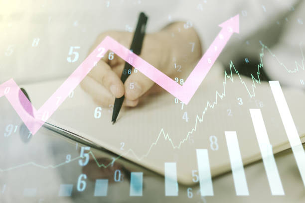 istock Multi exposure of abstract creative financial graph with upward arrow and man hand writing in notebook on background, forex and investment concept 1459003461