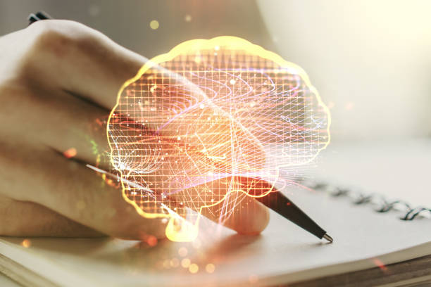 istock Creative artificial Intelligence concept with human brain hologram and man hand writing in notebook on background. Multiexposure 1459003481