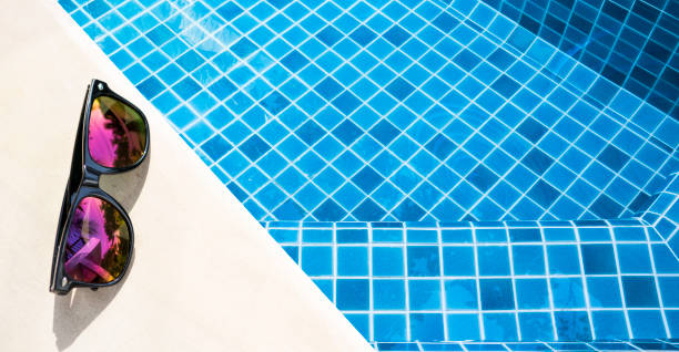 istock Sunglasses on swimming pool edge 1459005048