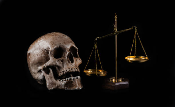 istock Golden scales and a human skull on a black background 1459010074