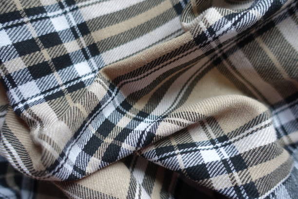 istock Folded beige, black and white cotton flannel tartan fabric 1459011057