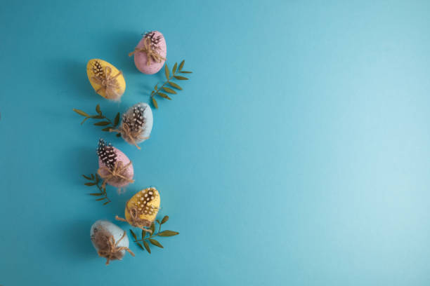 istock Decorated Easter eggs and quail spotted eggs in spring decor on a blue background copy space 1459013050