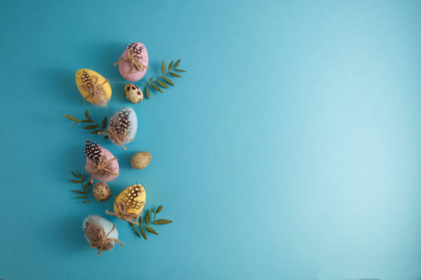 istock Decorated Easter eggs and quail spotted eggs in spring decor on a blue background copy space 1459013333