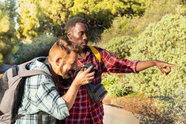 istock Two friends taking pictures in nature. 1459013777