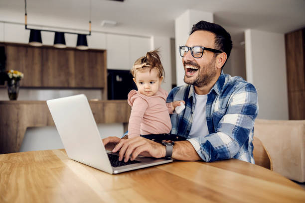 istock A father works on a laptop from home while his little daughter- boss monitors him. 1459015511