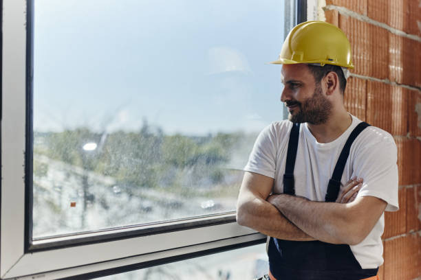 istock Smiling manual worker day dreaming by the window at construction site. 1459019080