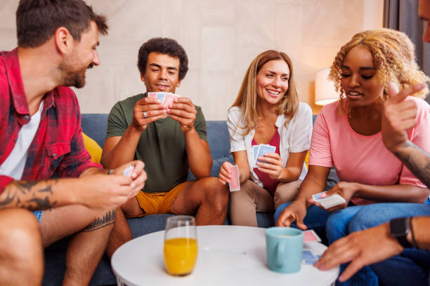 istock Friends having fun playing card games at home 1459019203