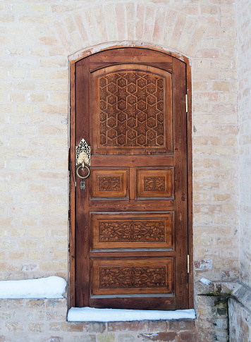 Wooden pattern in door with boor handle in Tashkent, Uzbekistan