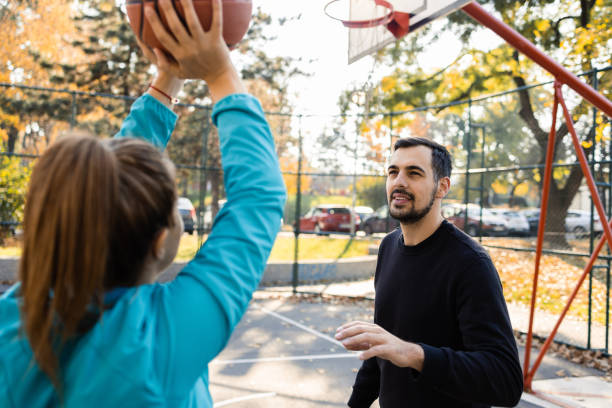 istock Young man and his girlfriend playing basketball 1459020372