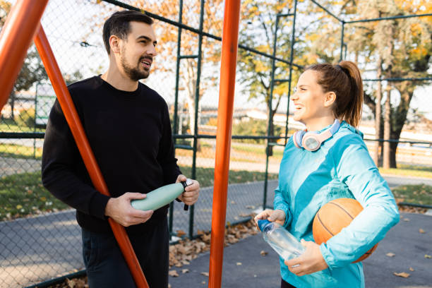 istock Happy couple having fun outdoors after playing basketball 1459020439