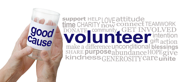 female hands holding a donations jar beside a VOLNTEER  word cloud isolated on a white  background