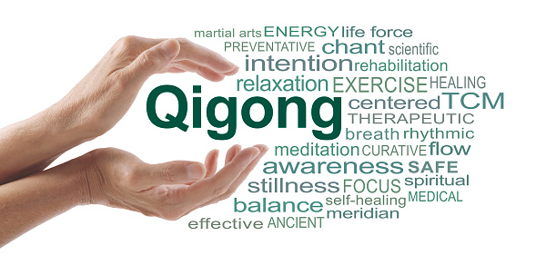 female hands cupped around the word QIGONG surrounded by relevant words isolated on a white background