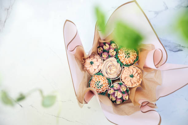 istock Cupcake decorated with white various colors flower icing isolated on white background. Shoot from top. Floral bouquet. Wedding cupcakes. Mothers Day,Birthday, Valentine Holiday 1459028184