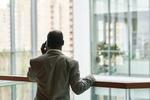 istock Back view of experienced chief executive officer talking on mobile phone 1459028218