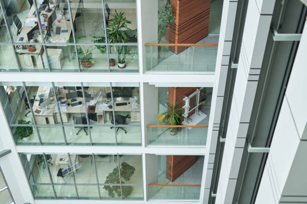 istock Part of multi-storey building with openspace offices behind large windows 1459028234