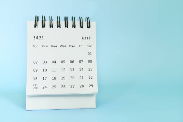 istock Selective focus of April 2023 desk calendar on blue background with copy space. 1459029054