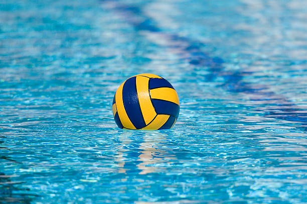 A yellow and blue ball floating in a pool http://i38.tinypic.com/2wq4jeo.jpg water polo photos stock pictures, royalty-free photos & images
