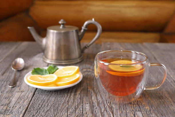 istock A glass cup of black tea with lemon and mint. 1459031592