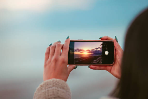 take a sunset photo with your phone stock photo