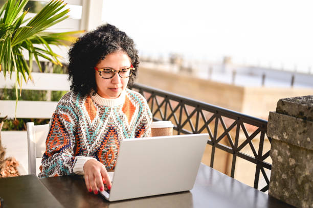 istock Brazilian mid adult woman working on computer remotely. 1459033094