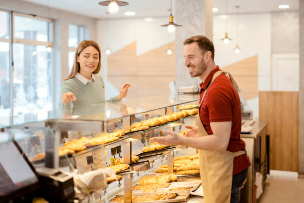 istock Salesman in His Bakery With a Female Customer 1459033551