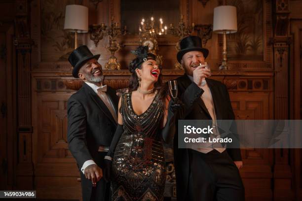 1920s Style Male And Female Friends In A Luxury Stately Home Setting Stock Photo - Download Image Now