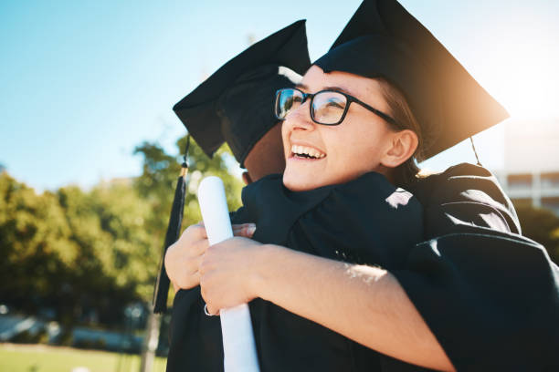 istock Graduation, hug and students with diploma from college for success, celebration and support in education. Certificate, happy and friends hugging after achievement at graduate event at a university 1459035341