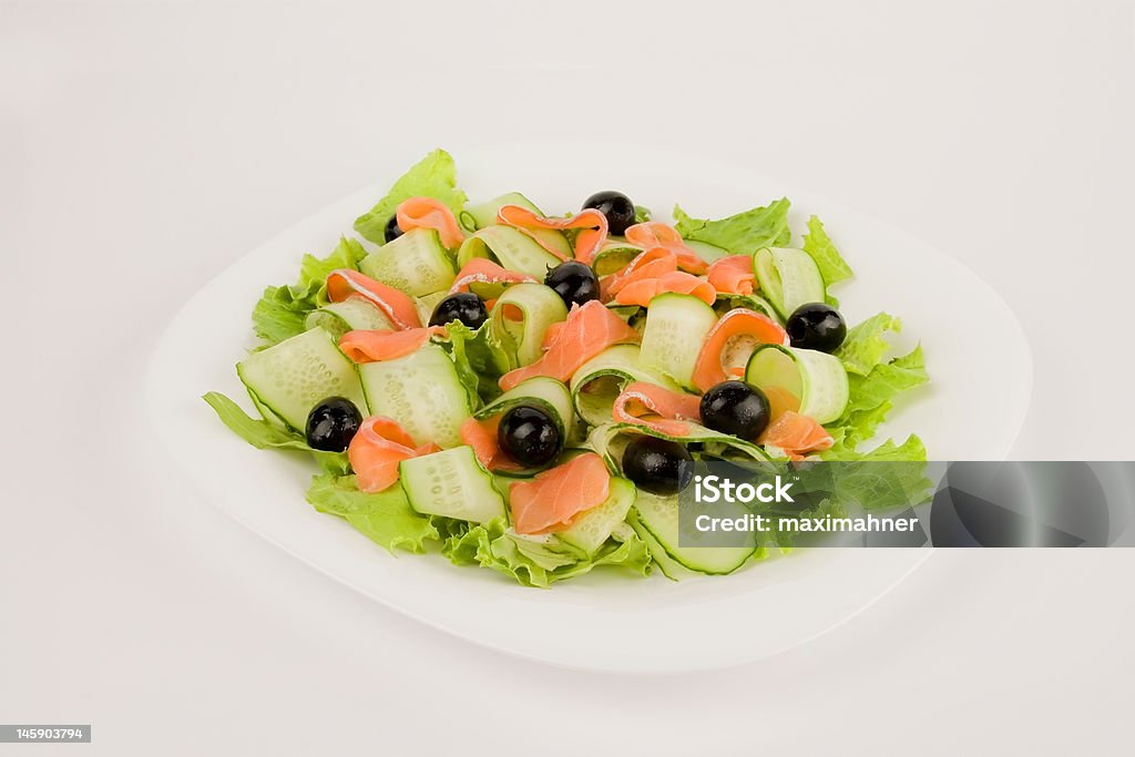 Salad with red fish and cucumbers Salad with red fish and cucumbers, clipping path included Black Color Stock Photo