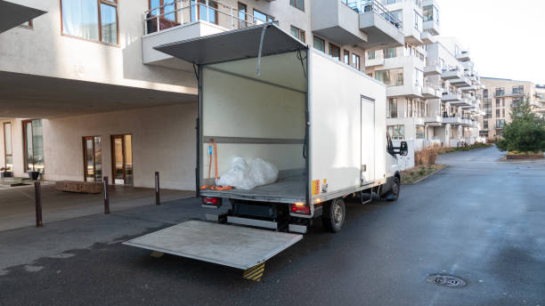istock White delivery truck with tailgate open in front of a building 1459042425