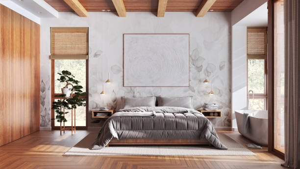 Modern wooden bedroom with bathtub in white and beige tones. Double bed, freestanding bathtub, parquet and wallpaper. Japandi interior design stock photo