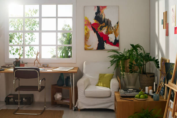 istock Workplace of modern artist by window of spacious home studio 1459043309