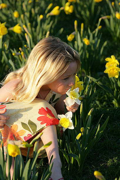 istock Girl smelling flowers on a summer day 145904408
