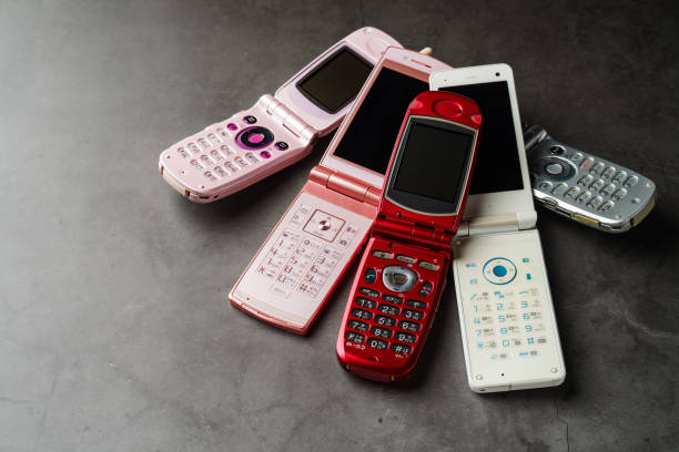 Old used cell phone on dark background Old used cell phone on dark background photo messaging stock pictures, royalty-free photos & images