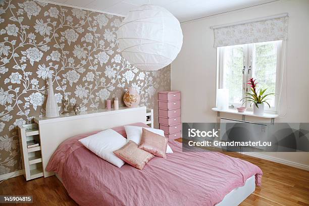A Beautiful Bedroom With Floral Wall And Pink Bed Sheets Stock Photo - Download Image Now