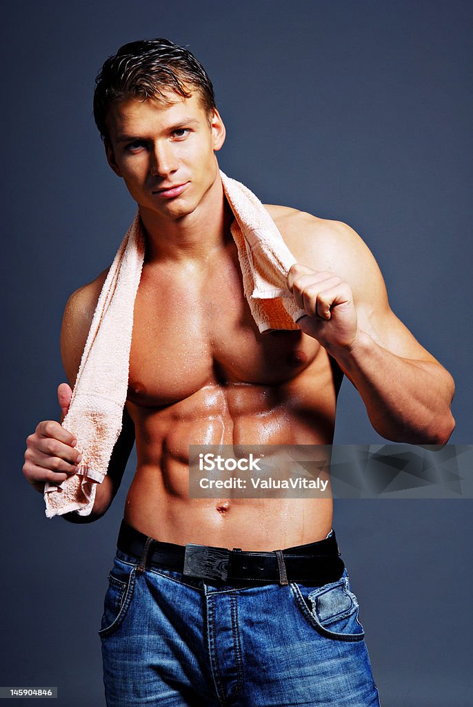 Wet & body Beautiful man with strong body holding the towel. 20-24 Years Stock Photo Wet & body Beautiful man with strong body holding the towel. 20-24 Years Stock Photo