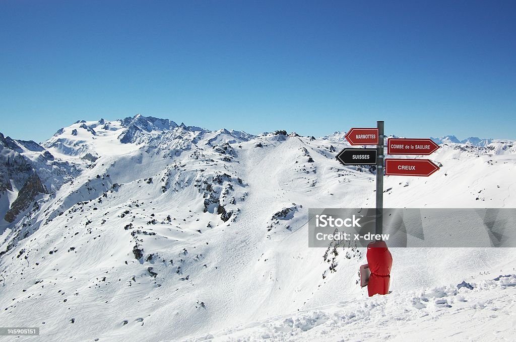 ski resort mountain view mountain winter landscape with ski slopes and direction signpost, horizontal. Les Menuires Stock Photo