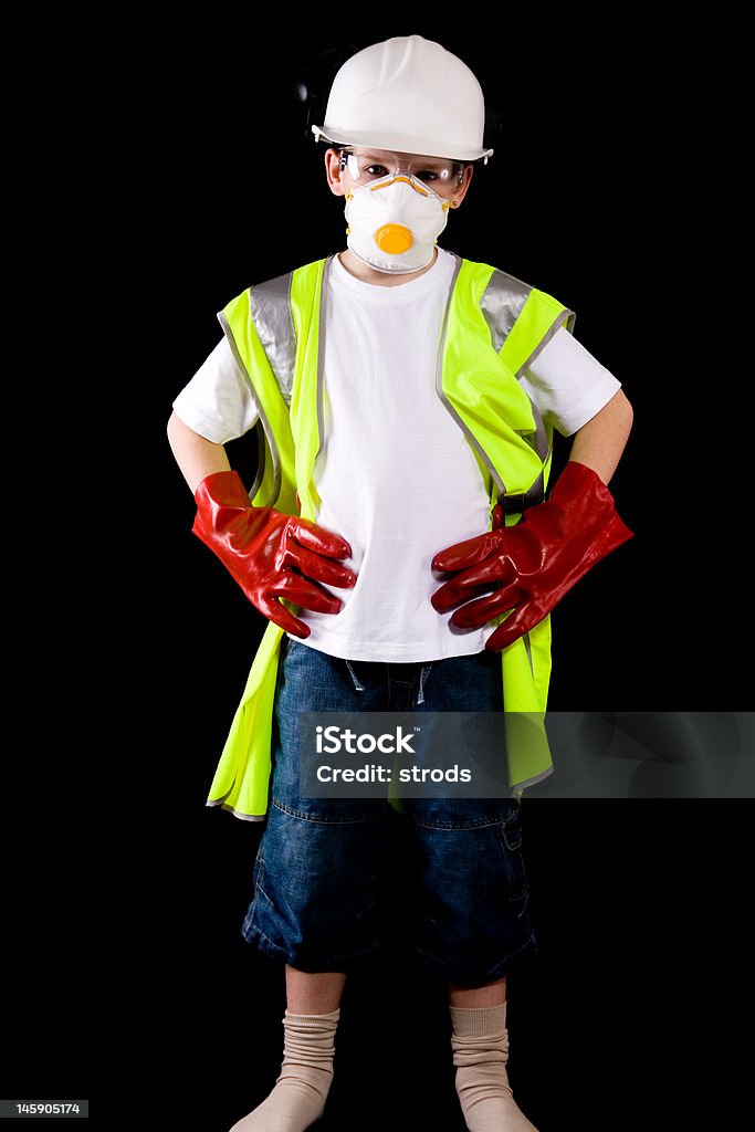 Giovane uomo rivolto verso un vestito in Indumento protettivo - Foto stock royalty-free di Elmetto da cantiere