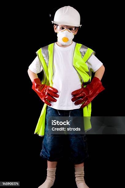 Giovane Uomo Rivolto Verso Un Vestito In Indumento Protettivo - Fotografie stock e altre immagini di Elmetto da cantiere