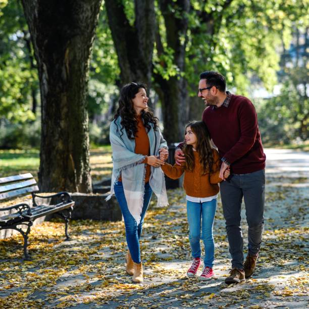 istock Happy parents taking a walk with their little daughter 1459056422