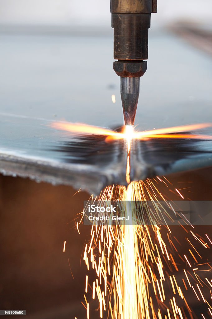 Drilling bit working on iron surface causing fire flame a close up of track torch burning steel Automatic Welding Torch Stock Photo