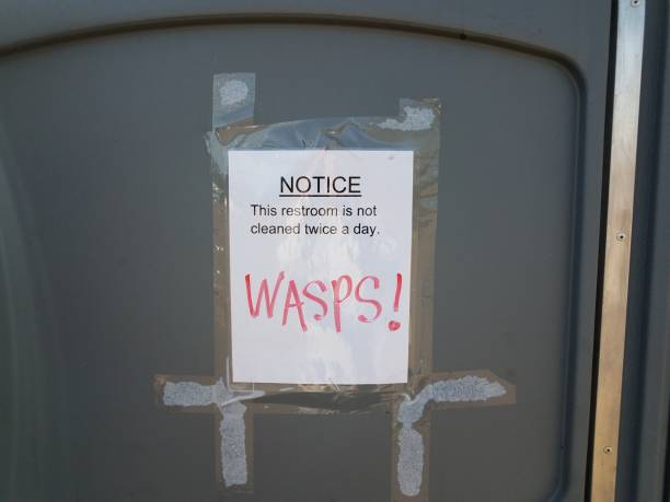 istock notice this bathroom is not cleaned twice a day and wasps sign 1459057111