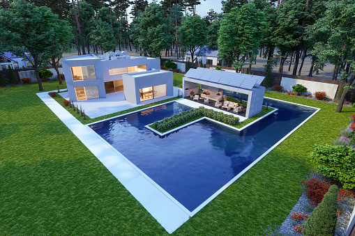 Modern two floors white villa with wooden vertical panels. Luxury exterior concept with beautiful garden. Summer time.