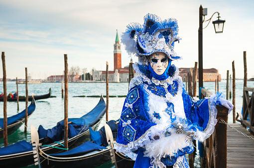 Venice, Italy - February 16, 2020: Beautiful colorful masks at traditional Venice Carnival in Venice, Italy