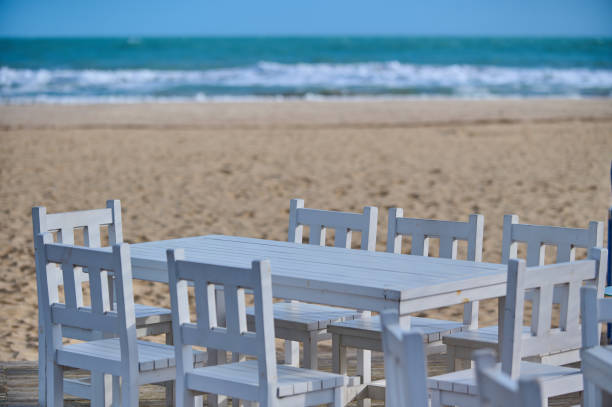 istock Summer empty outdoor cafe on the seashore at sunrise 1459060987