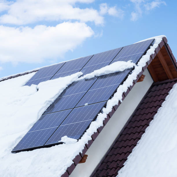 solar panels on the roof covered with snow in winter