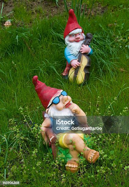 Lounging Garden Gnome Statues In The Grass Stock Photo - Download Image Now - Garden Gnome, Gnome, Relaxation