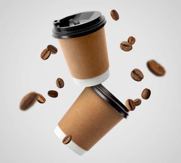 istock Coffee to go. Paper cups and roasted beans flying on light background 1459064397